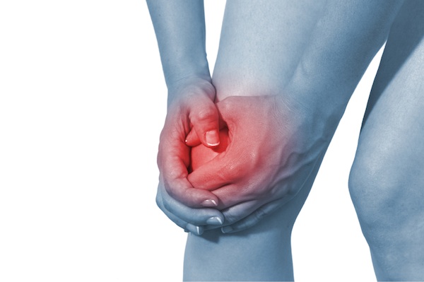 Acute pain in a woman knee. Isolation on a white background