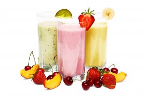 Fruit smoothies with cherry, strawberry and peach isolated on white background