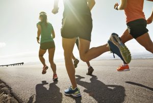 Shot of a group of people running along a road