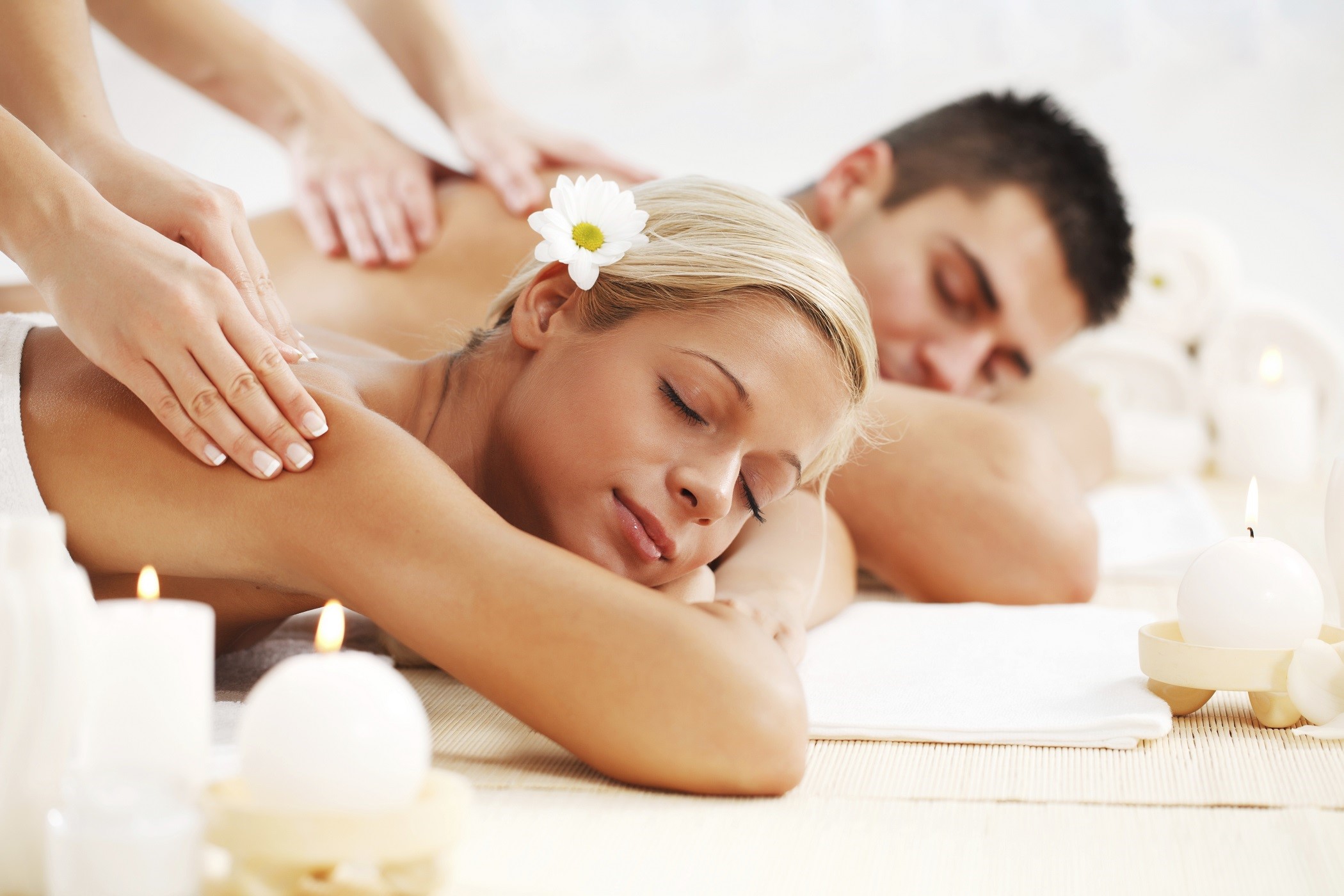 Young couple is having a back massage at the spa centre.